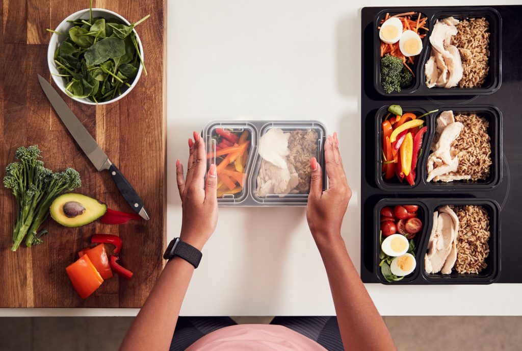 Overhead Shot Of Woman Preparing Batch Of Healthy Meals At Home In Kitchen Healthy Eating Guide