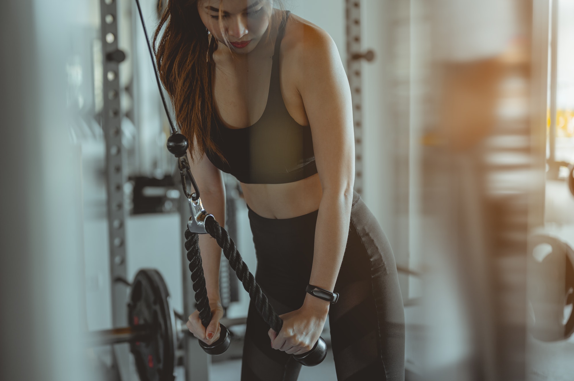 A women working out training arms in gym gaining weight pumping up muscles with dumbbells