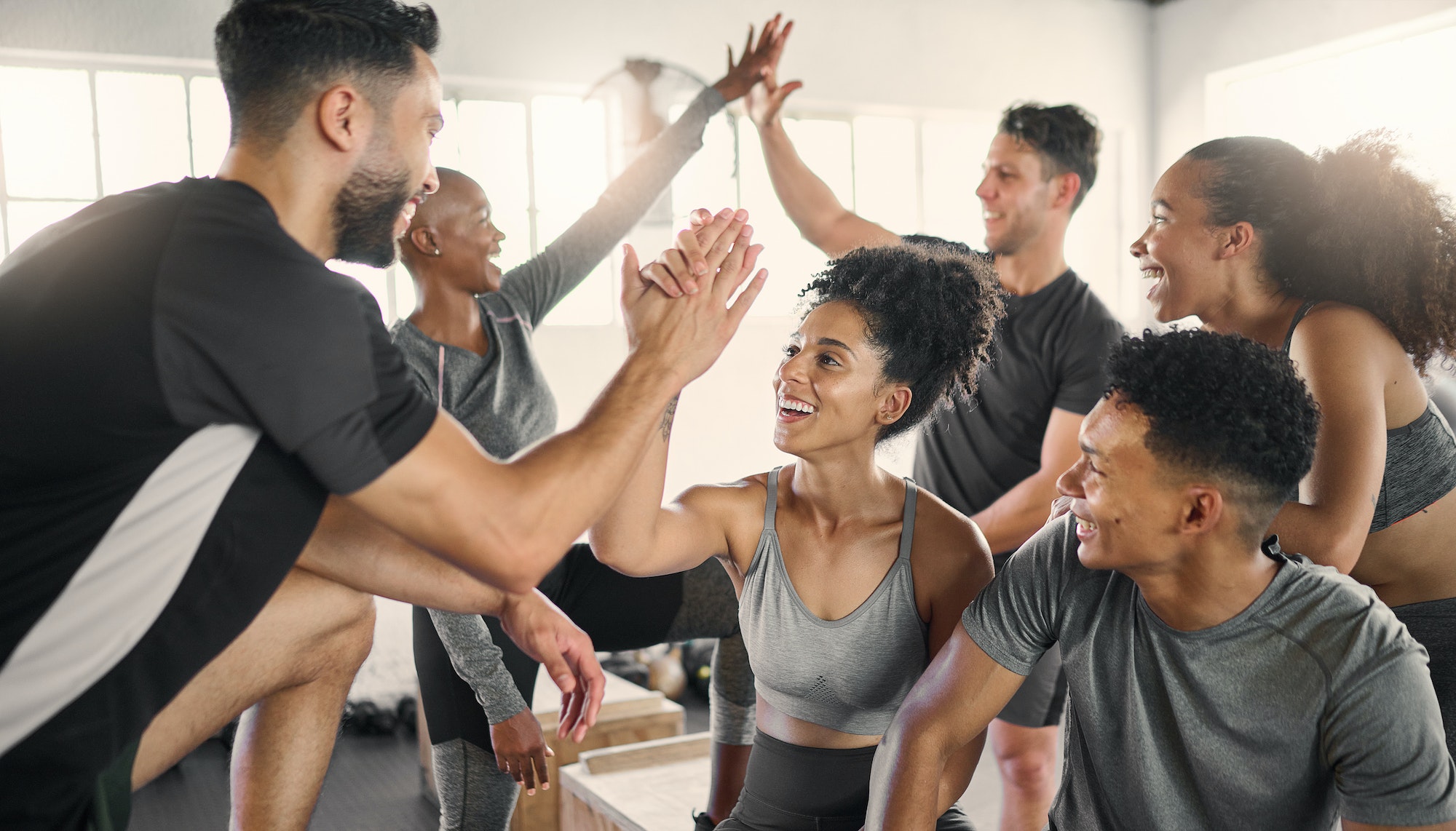 Fitness, high five and group at the gym in celebration of fitness goal, achievement and success. Sp